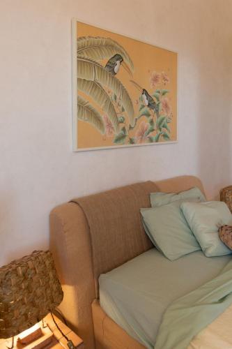 a couch in a living room with a picture on the wall at Villa Desiderio TUSCANY in Pistoia