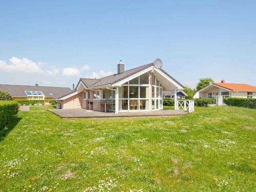 a house with a large lawn in front of it at 6 person holiday home in GROEMITZ in Grömitz