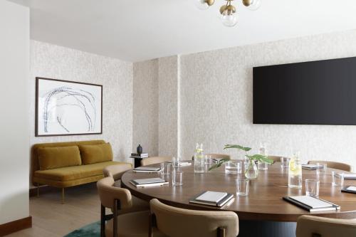 a dining room with a table and a couch at Kimpton - Sylvan Hotel, an IHG Hotel in Atlanta