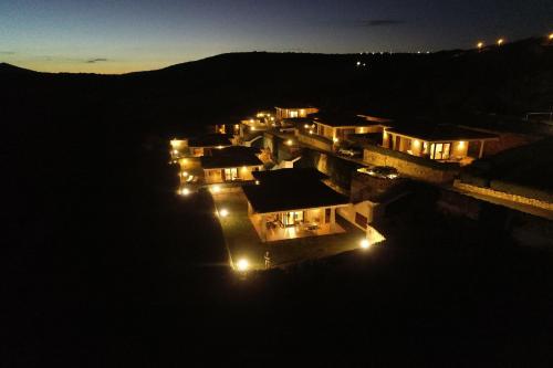 a group of houses lit up at night at Le Ville Le Saline in Palau