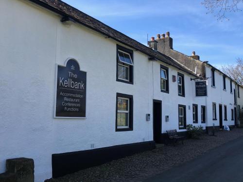 a white building with a sign on the side of it at The Kellbank in Gosforth