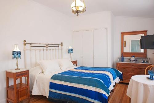 a bedroom with a bed and a dresser and a mirror at Hotel Casa Somerscales in Valparaíso