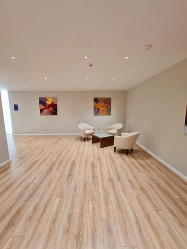 a large room with furniture and paintings on the wall at Regina Blu in Vlorë