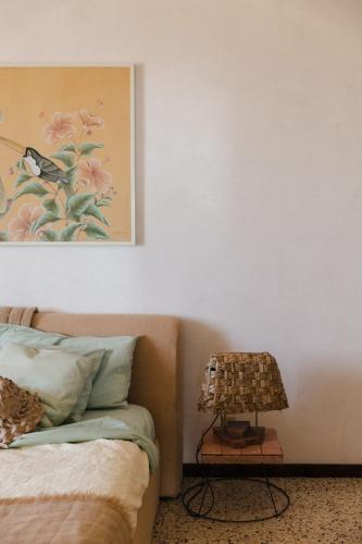 a bedroom with a bed and a table with a lamp at Villa Desiderio TUSCANY in Pistoia