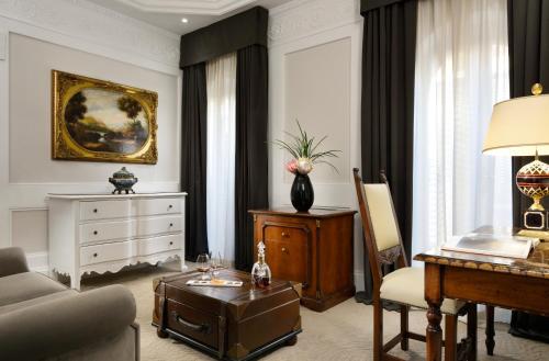 a living room filled with furniture and a fireplace at Hotel Splendide Royal - The Leading Hotels of the World in Rome