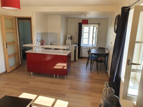 a kitchen with a sink and a table in a room at Appartement en plein centre de Deauville 2éme in Deauville