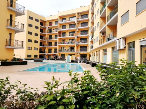 an image of an apartment complex with a swimming pool at Mar & Serra in Armação de Pêra