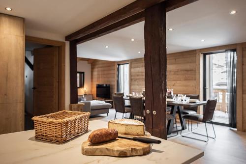 a kitchen and living room with a table and a dining room at Nouveau et spacieux, Place de l'Eglise et terrasse privative in La Clusaz