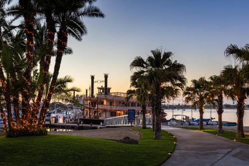 a house with palm trees in front of a marina at Bahia Resort Hotel in San Diego