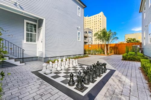 a chess board on a patio with at Hosteeva Modern Condo Near Magazine St & Close to FQ in New Orleans