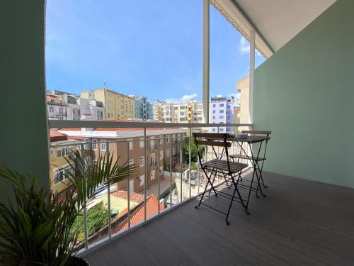 a balcony with a table and chairs on a balcony at Green Heart Hostel in Lisbon