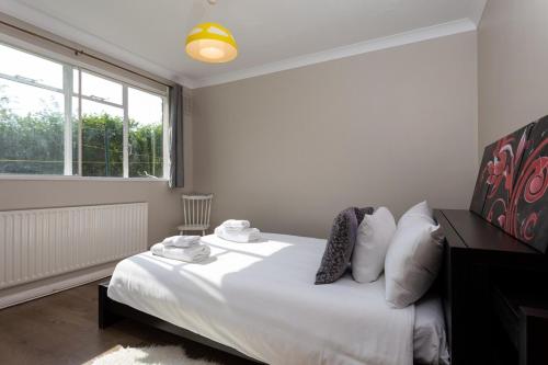 ロンドンにあるFantastic 2BD Flat in South London!のベッドルーム1室(白いシーツ付きのベッド1台、窓付)