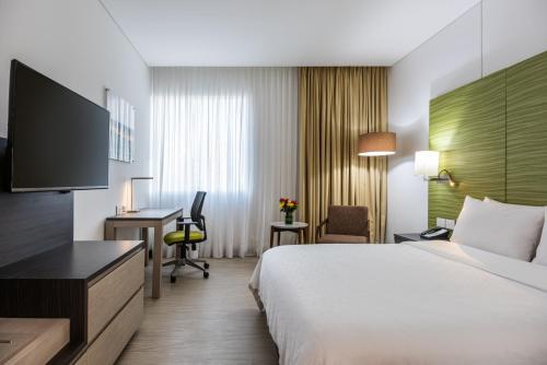 a hotel room with a bed and a desk at Holiday Inn Express - Cartagena Bocagrande by IHG in Cartagena de Indias