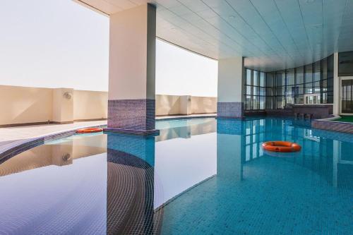 a large swimming pool with a large pool at Artistic 1 Bedroom in JLT Close to Metro in Dubai