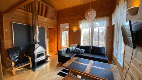 a living room with a couch and a wood stove at Havurinne in Loppi