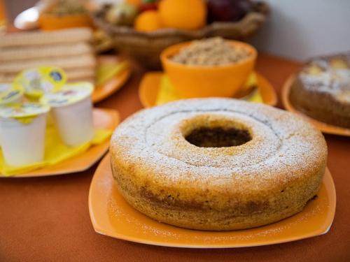 a donut on an orange plate on a table at Bed and Breakfast Dorgali in Dorgali