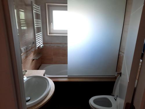 La petite salle de bains est pourvue d'un lavabo et de toilettes. dans l'établissement Apartamento Playa Riberuca 1 Suances, à Suances