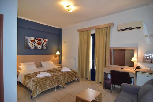 a hotel room with a bed and a desk at Iridanos in Antikyra