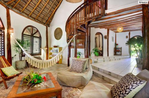 a living room with a couch and a table at Beachfront bungalows- Soliman Bay in Tulum