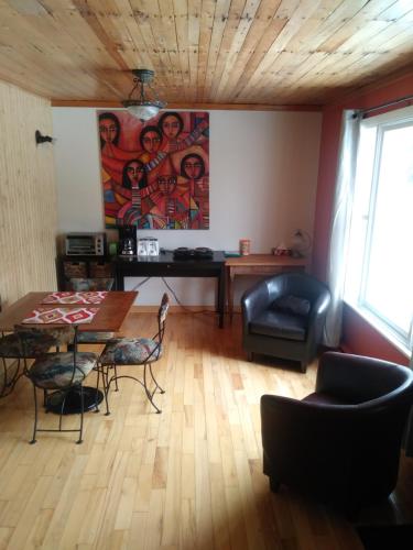 a living room with a table and chairs at Gite Pousse Pioche in Notre-Dame-des-Monts
