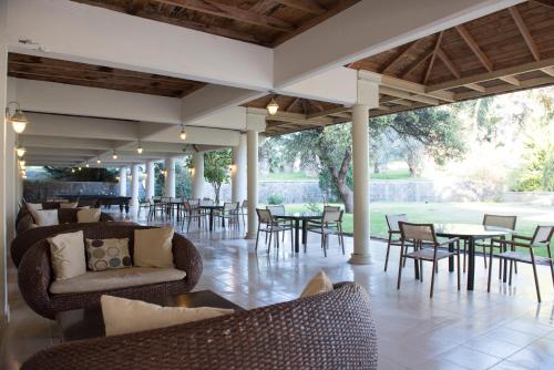 an outdoor patio with tables and chairs and tables and chairs at X Life Hotel Sarıgerme 15 - Adult Hotel in Sarigerme