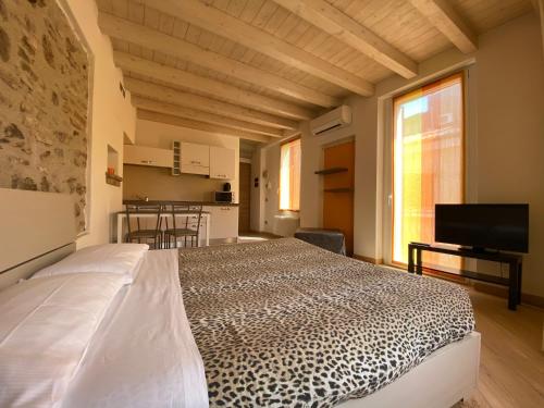 a bedroom with a bed with a leopard print bedspread at Appartamenti Mavino in Sirmione