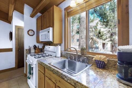 a kitchen with a sink and a stove and a window at Northstar Gold Bend Retreat in Truckee