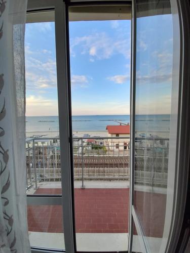 a view of the beach from a window at Appartamento Fronte Mare in Falconara Marittima