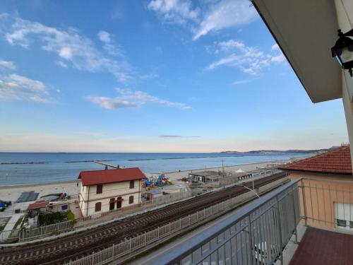 a view of the beach from the balcony of a condo at Appartamento Fronte Mare in Falconara Marittima