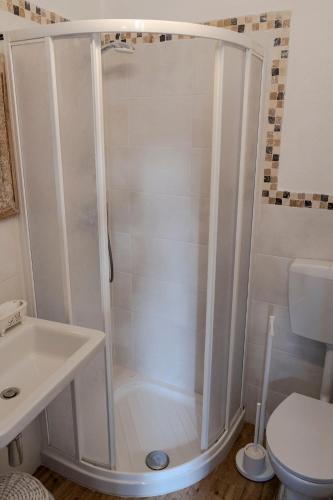 a bathroom with a shower with a sink and a toilet at Solemagia in Vernazza