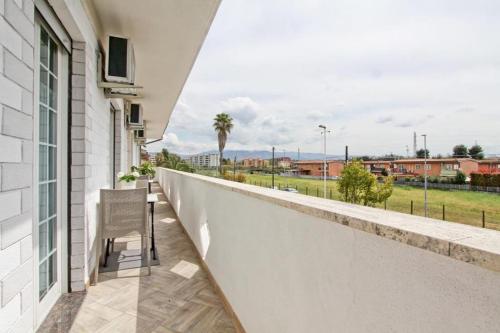 a balcony with a chair and a view of a field at Hotel La Maison Delle Terme in Tivoli Terme