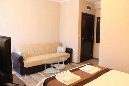 a living room with a couch and a table at Къща за гости Тони in Zlatograd