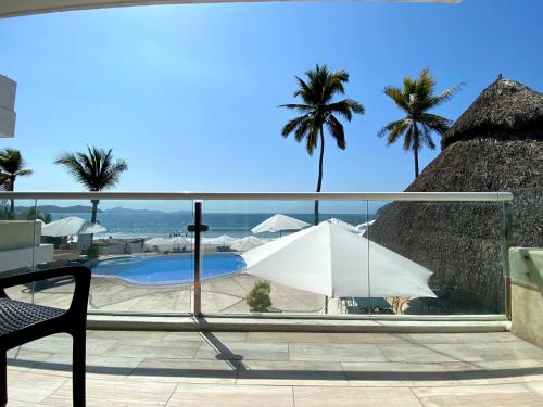 a view from the balcony of a resort with a pool at Mar Celeste in Manzanillo