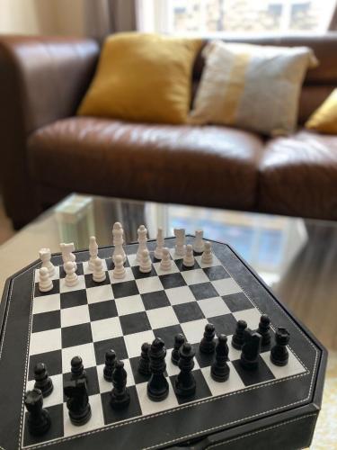 a chess board on a table in a living room at Fabulous 2 bed Historic Ground floor apartment Belper with free car parking next to property in Belper