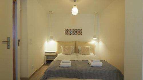 a bedroom with a bed with two towels on it at Sao Vicente - Lissabon Altstadt in Lisbon
