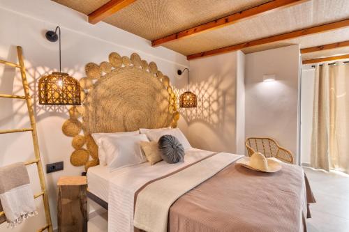 a bedroom with a large bed with a large headboard at Aeolia Boutique Studios in Ermoupoli