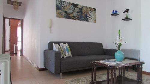 a living room with a couch and a table at Valley of Nuns Holiday Apartments in Curral das Freiras
