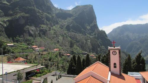 a church with a cross on top of a mountain at Valley of Nuns Holiday Apartments in Curral das Freiras