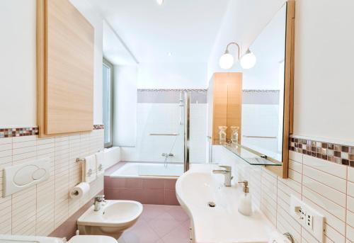 a bathroom with a sink and a toilet and a tub at Ischia Domus in Ischia