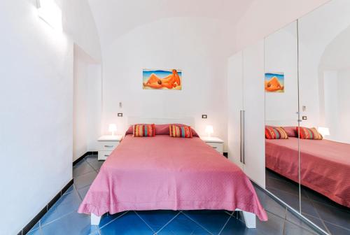 a bedroom with two beds and mirrors at Ischia Domus in Ischia