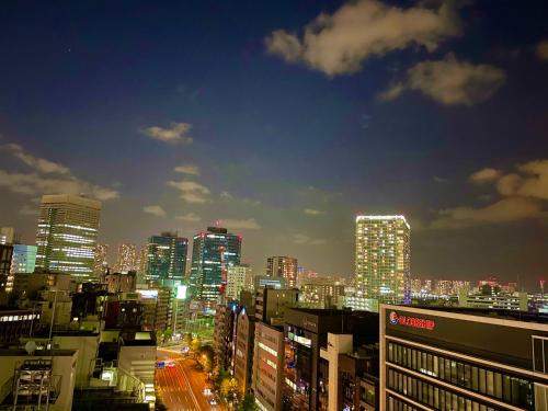 a city skyline at night with lit up buildings at APA Hotel Mita Ekimae in Tokyo
