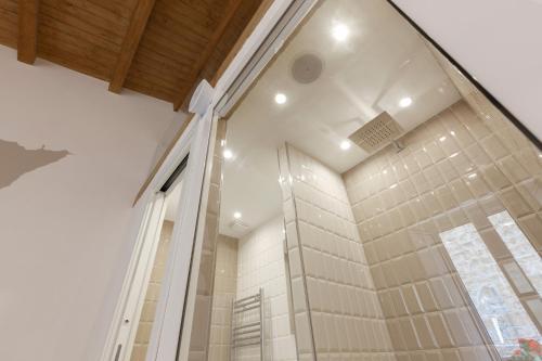 a shower in a bathroom with a glass wall at Sicily Dreams Luxury in Agrigento