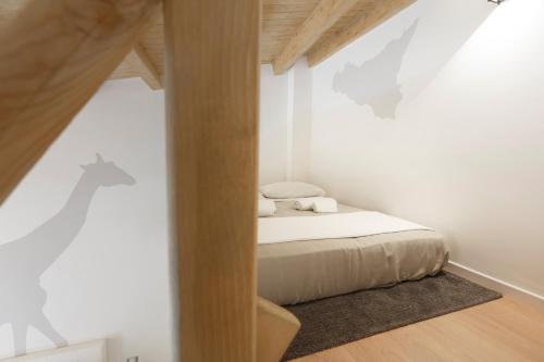 a bedroom with a bed in a white wall at Sicily Dreams Luxury in Agrigento