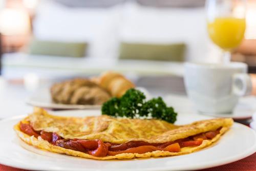 a plate of food with a pie on a table at Hotel Vilar América in Bogotá