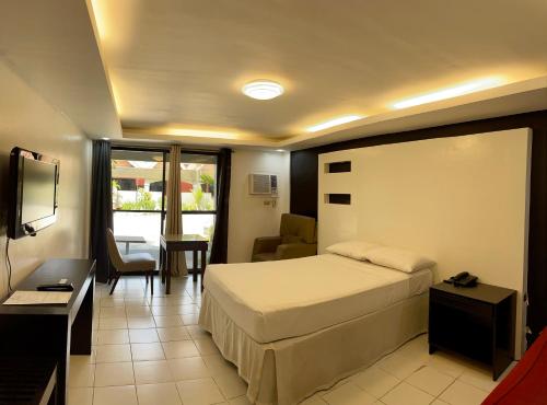 a bedroom with a bed and a living room at Maharajah Hotel in Angeles