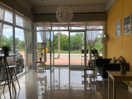 a living room with a large glass door at Day II Hotel in Ang Sila