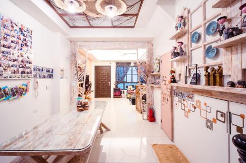 a dining room with a table and a wall of plates at 安平72號民宿 in Tainan