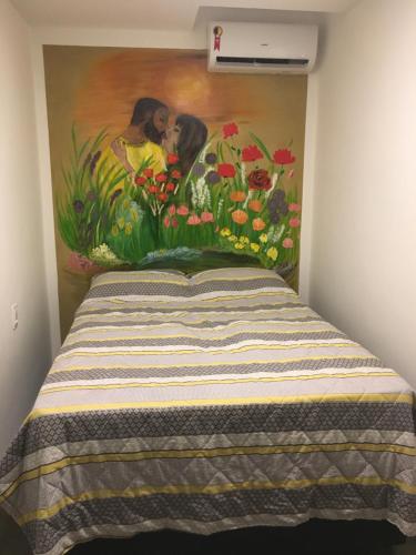 a bedroom with a painting on the wall at Guest Apartment Paulo in Recife