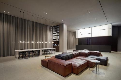 a living room with a couch and a table and chairs at Shilla Stay Busan Gimhae Airport - Noksan in Busan
