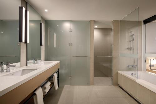 a large bathroom with two sinks and a shower at Shilla Stay Seobusan Gimhae Airport in Busan